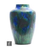 A late 19th to early 20th Century Minton Hollins Astra Ware vase decorated in a streaked blue and