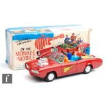 A Japanese Aoshin The Monkees Monkeemobile tinplate battery operated car, finished in red with green