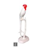 A Noritake model of a cockerel perched on a branch with a long trailing tail, all in white with