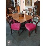 A set of six Victorian mahogany balloon back dining chairs on turned legs terminating in peg feet,