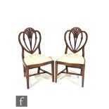 A set of six Hepplewhite style mahogany dining chairs by Rackstraw, the plume carved shield backs