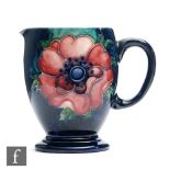 A small Moorcroft footed jug decorated in the Anemone pattern, impressed signature mark, height 8.
