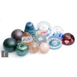 An assorted collection of 20th Century glass paperweights to include studio glass examples with