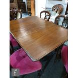 A Victorian mahogany drop flap dining table, the moulded edge top over a plain frieze, on turned