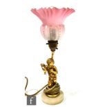 A 20th Century gilt table lamp modelled as a cherub holding a bunch of grapes and a ewer beneath a