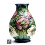 A limited edition Moorcroft Pottery baluster form vase decorated in the Lenten Rose pattern designed