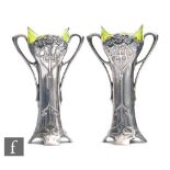 A pair of WMF flower vases, the twin handled silver plated vases decorated with floral Art Nouveau