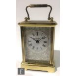 A Taylor and Bligh contemporary English carriage clock, the white enamelled dial and bevelled