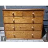 A Victorian stained pine chest of two short and three long drawers, turned wood handles on a