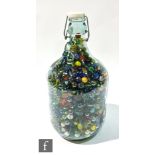 A large collection of vintage marbles contained in a glass flagon, height 37cm.