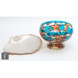 A contemporary glass pedestal bowl decorated with hand painted sun, moon, star and fish motifs,