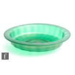 A 1930s Italian shallow glass bowl with fluted body and flat rim with a fine fissured green