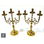 A pair of early 20th Century brass altar candelabras with centre sconce, on scroll supports,