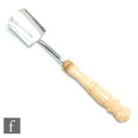 A William IV hallmarked silver Stilton scoop of plain spade form terminating in faux ivory handle,