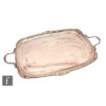 An early 20th Century hallmarked silver cushioned rectangular twin handled tray of plain form with