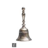 A hallmarked silver table bell of typical form, engraved with initials J.J.G, weight 4.5oz,
