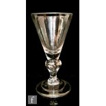 An 18th Century heavy baluster goblet circa 1710, the conical bowl above a teared inverted