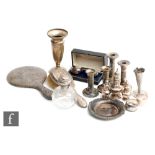 A parcel lot of assorted hallmarked silver and white metal items to include a piano candlestick,