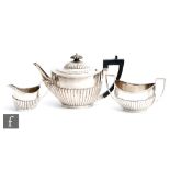 A composed hallmarked silver three piece boat shaped tea pot with part fluted decoration, total