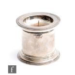 A hallmarked silver candle stand of plain form with circular stepped base and reeded border to