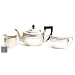 A hallmarked silver three piece tea set of plain panelled boat shaped form, total weight 30oz,