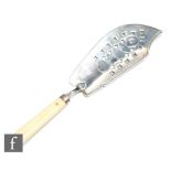 A George III hallmarked silver fish slice with pierced blade below ivory handle, length 28cm, London