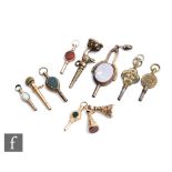 Eleven assorted gilt metal pocket watch keys and fobs to include one modelled as a swan's head and