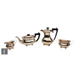 A hallmarked silver four piece tea set of plain boat shaped form each raised on four ball feet,