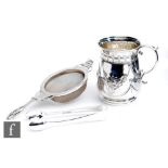 An Edwardian hallmarked silver small tankard with embossed and engraved foliate swag decoration,