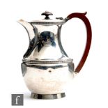 A hallmarked silver hot water pot of plain baluster form with central gadroon band, weight 14.5oz,