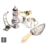 Five assorted hallmarked silver items to include a trowel, a small pedestal bowl, a sugar castor,