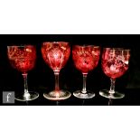 A pair of late 19th to early 20th Century Stourbridge cranberry bowl wine glasses engraved with a
