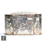 A hallmarked silver cushioned oval trinket box with engraved and embossed foliate swag decoration