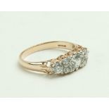 A 14ct red or rose gold 2.9 gm Ladies Ring, with a large central cubic zirconia, flanked each side