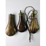 Three antique copper Powder Flasks, two plain and one engraved. (3)