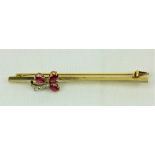 An 18ct gold ruby and diamond Brooch Set, with five old cut diamonds creating a floral design (
