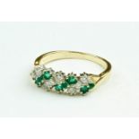 A fine quality ladies Cluster Ring, with eight diamonds and emeralds of variant sizes, set in gold