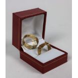 A 9ct gold etched Gentleman's Band; together with an 18ct gold Ladies Buckle design Band decorated
