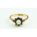 An attractive Ladies gold cluster Ring, with central pearl surrounded by eight sapphires, size Q 1/