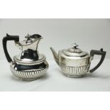 A silver Hot Water Pot, with half reeded oval body and gadroon edge with ebonised wooden handle, 656