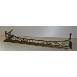 An Edwardian brass Fire Curb, with pillar supports and scroll design on step plinth base, 150cms (