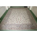 A fine quality silk type Carpet, with an overall pattern of varied flowers on a beige ground, inside