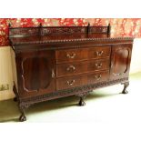 A Chippendale style carved mahogany Sideboard, with fretwork back rail, three long centre drawers
