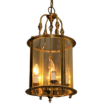 A Georgian style brass Hall Lantern, with domed glass and shaped supports, 2' high (61cms). (1)