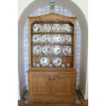 A good quality figured pine Dresser, the angled cornice over a four shelf open top, on a base with