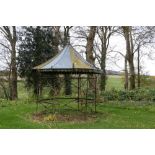 An attractive hexagonal shaped wrought iron Garden Gazebo, with galvanised domed roof, some
