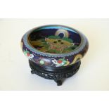 A Chinese cloisonné Dragon Bowl, of low proportions, with Oriental wooded stand. (1)