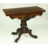 A Victorian fold-over rosewood Card Table, with shaped C scroll and leaf carved frieze on a heavy