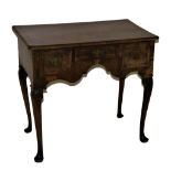 An early 18th Century walnut Lowboy, the segmented figured top with herringbone crossbanded and re-