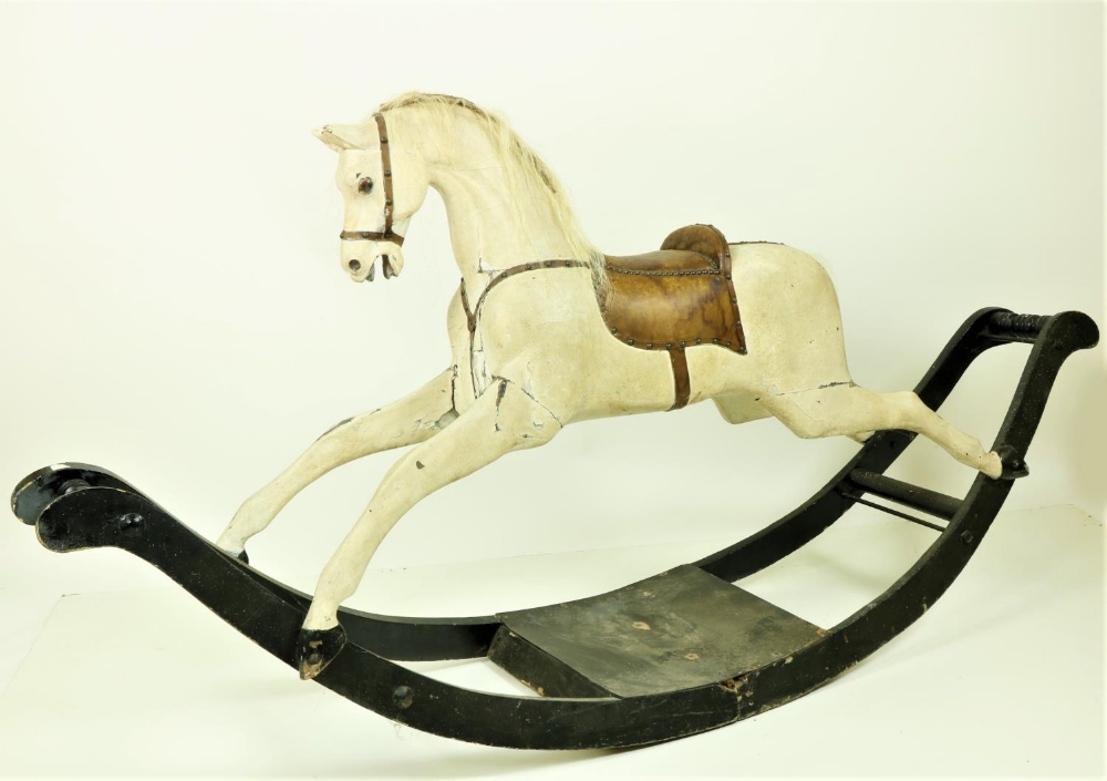 A good old Edwardian black and white painted wooden Rocking Horse, with leather saddle, 211cms (83")